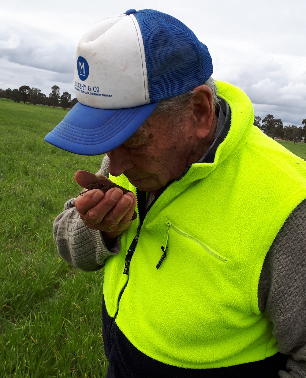 Regenerative farmer Calvin Muller smells his soil