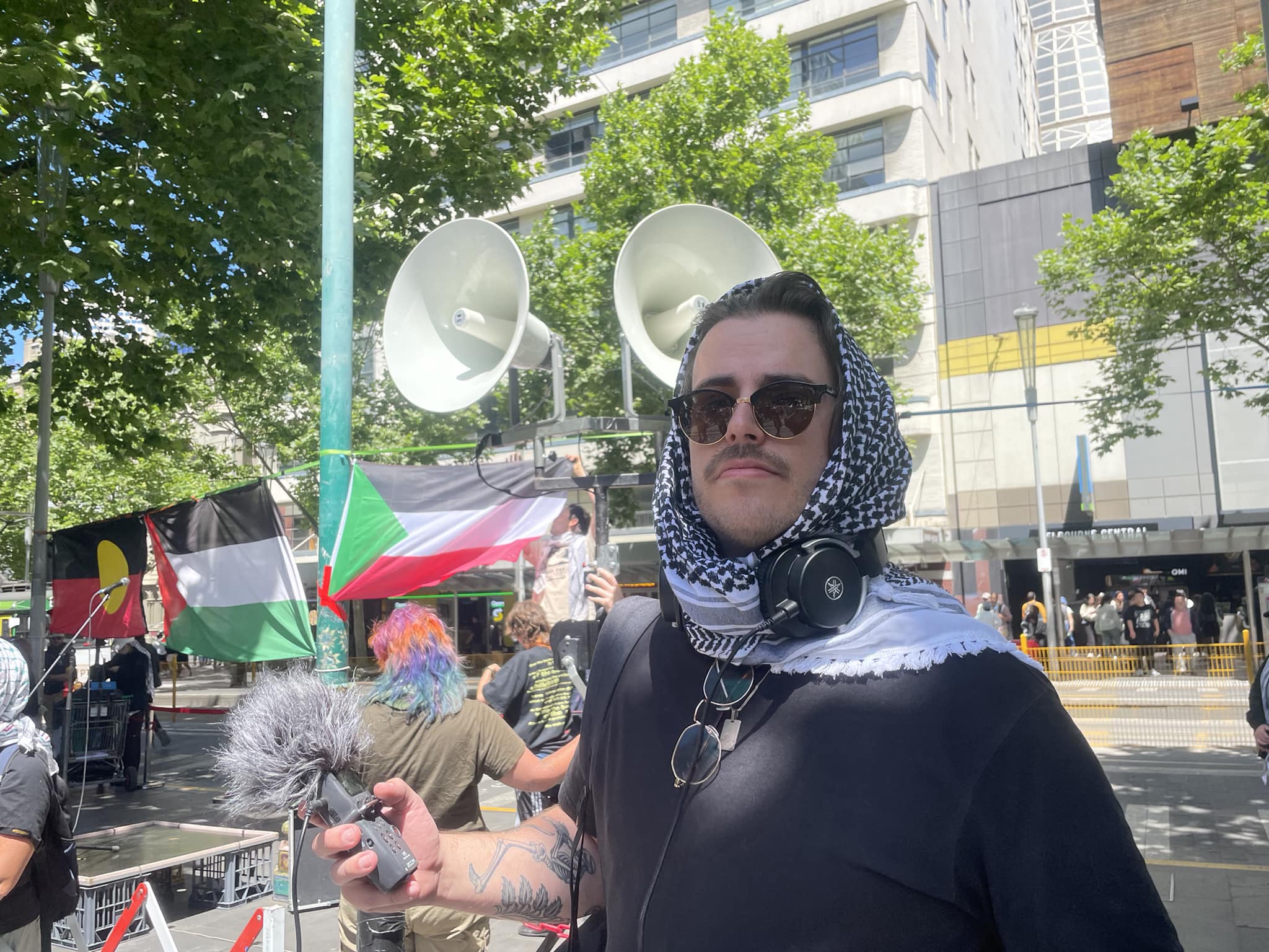 Volunteer wearing keffiyeh at rally