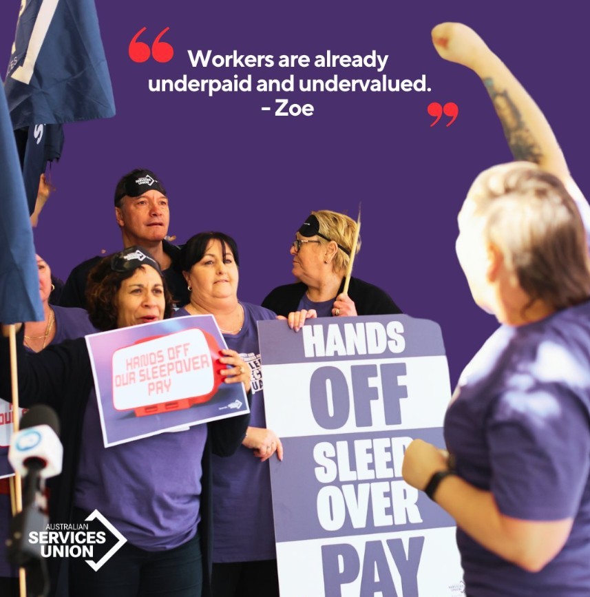 Hands Off Sleepover Pay! Rally of people with signs wearing purple and eye masks demanding hands off sleepover pay.