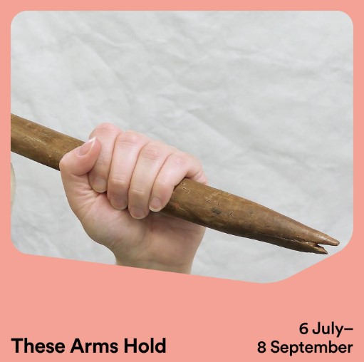 These Arms Hold. Hand holding women's weaponry against white background and pink border. 