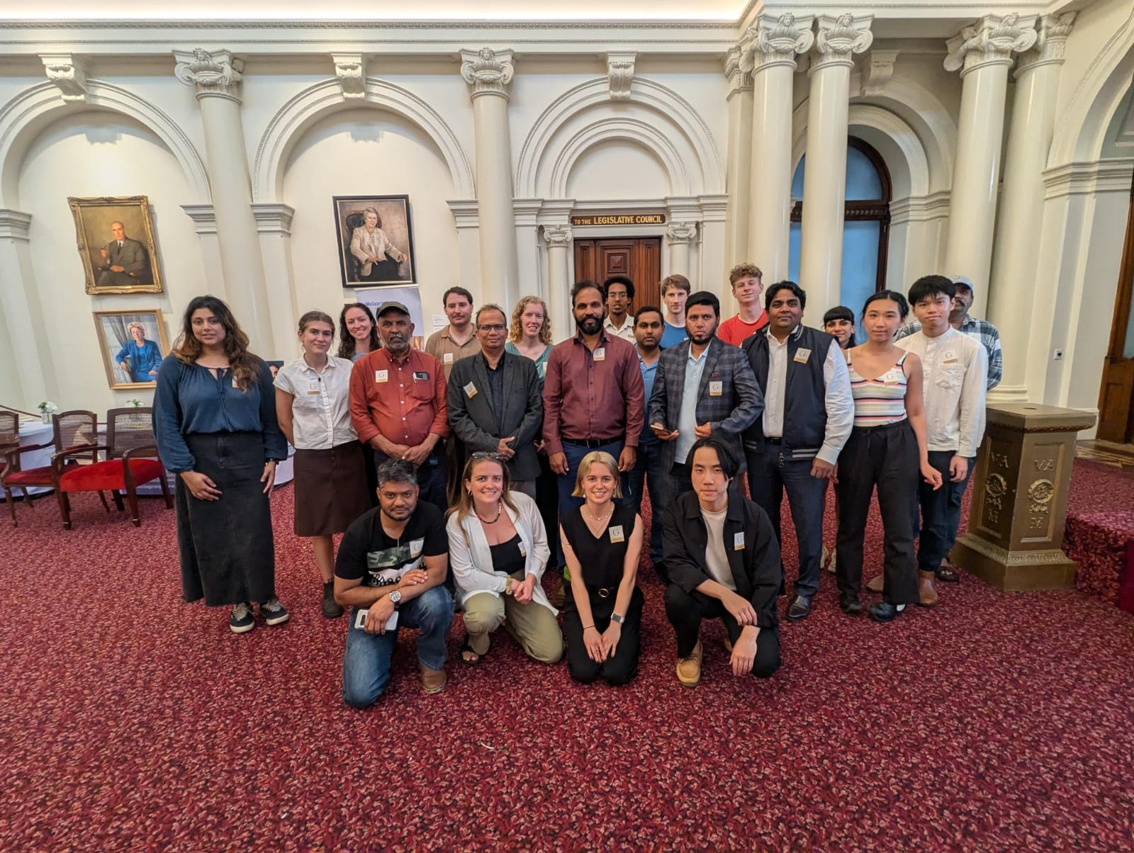 A photograph of protesters gathered together inside parliament house in Victoria.  