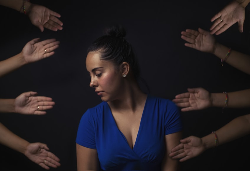 Woman turning away with hands reaching out to her