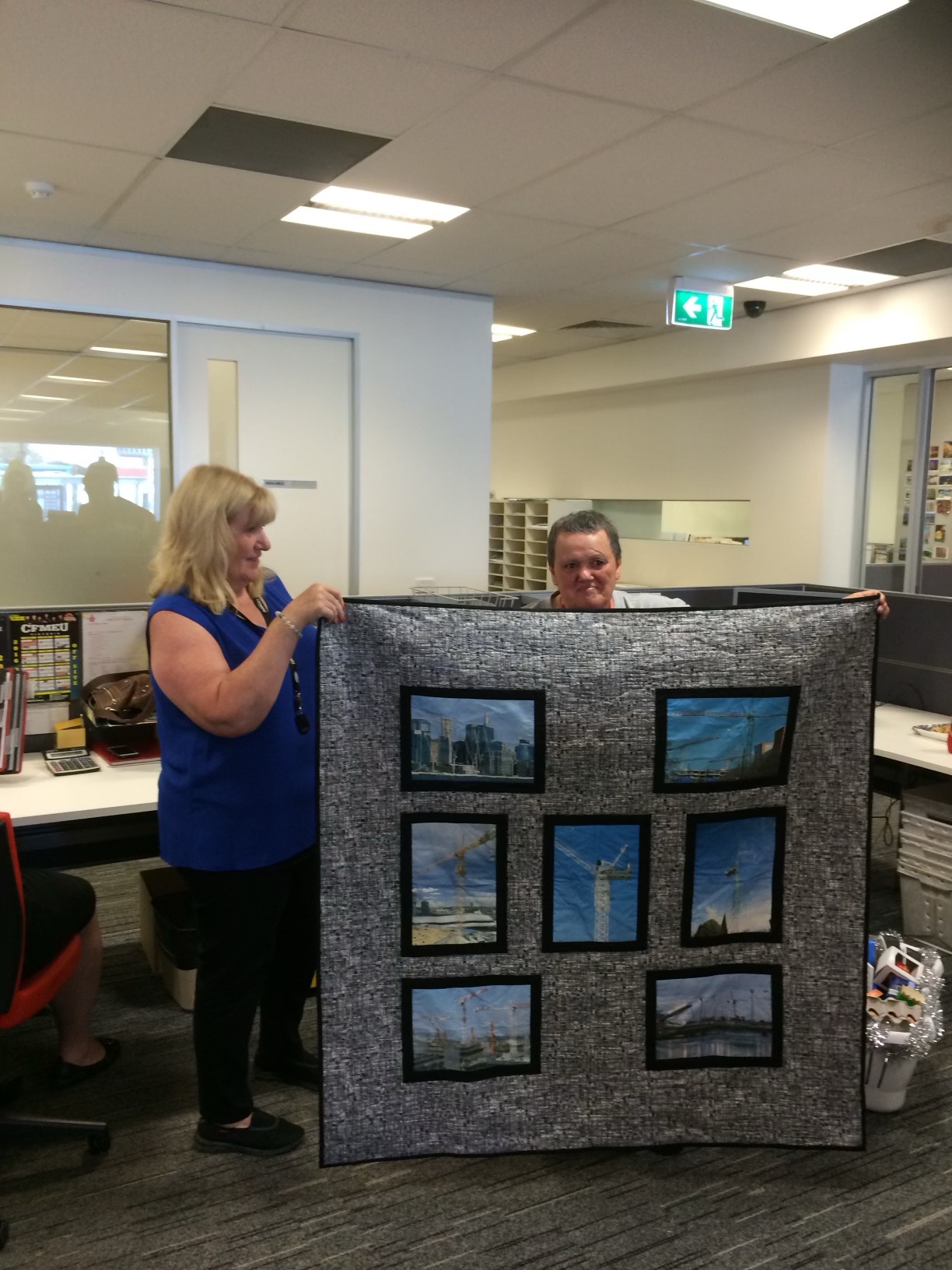 Edna, a life member of the CFMEU, on the right getting her favourite possession her crane quilt
