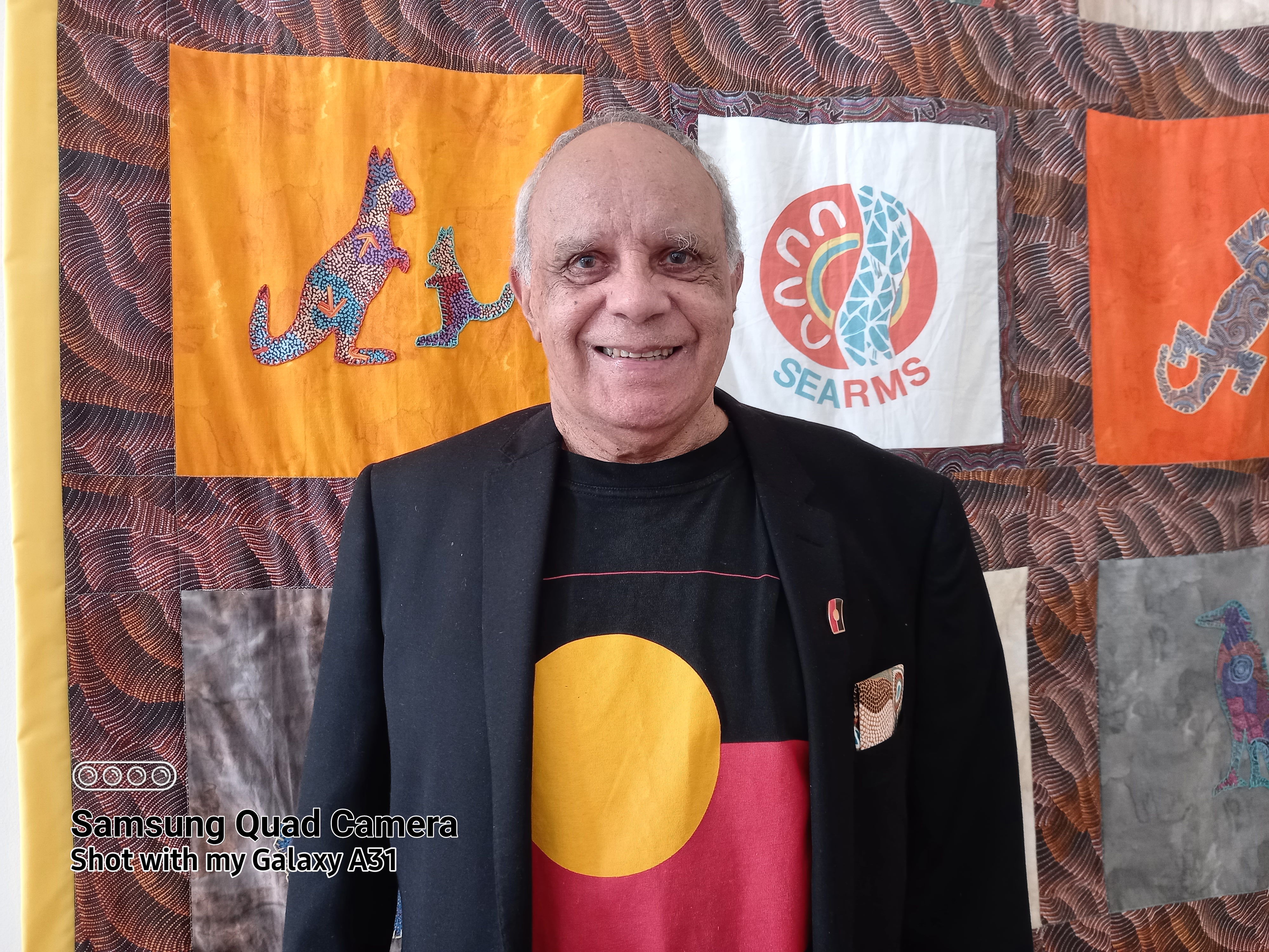 A smiling aboriginal man.