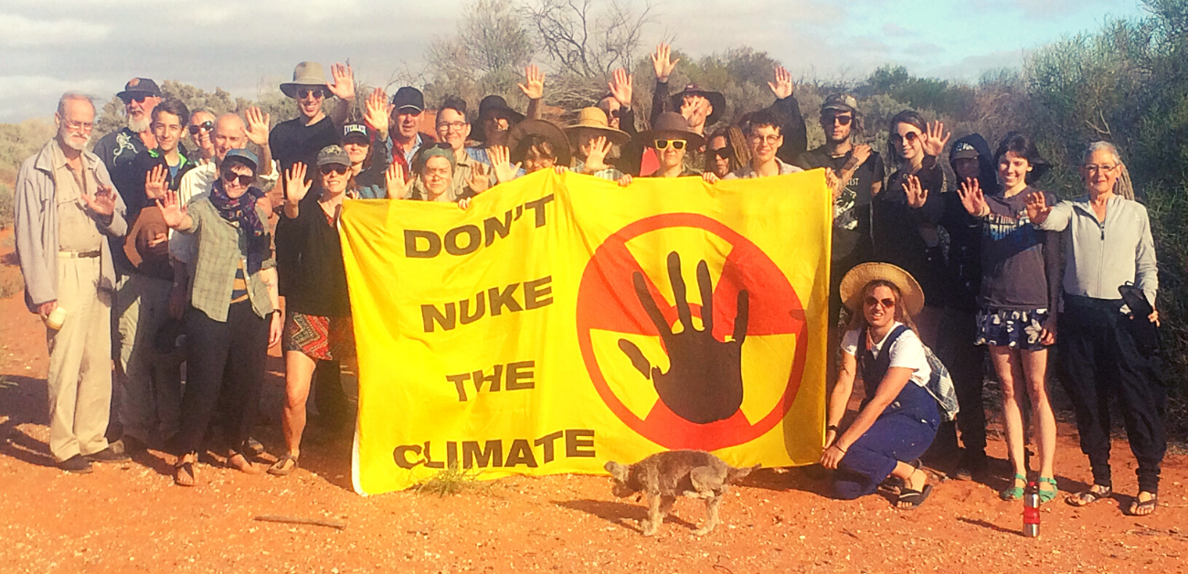 A group of activists hold a sign saying 'Don't Nuke the Climate'. Courtesy: Friends of the Earth