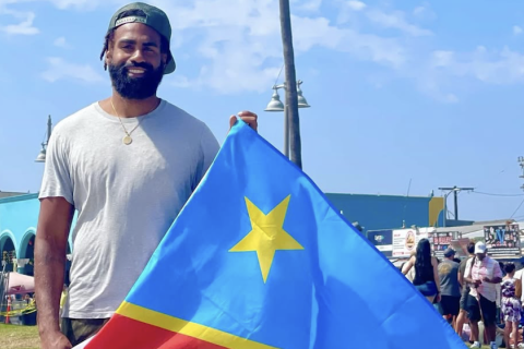 Image: Héritier Lumumba holding a DRC flag | instagram.com/hlumumba