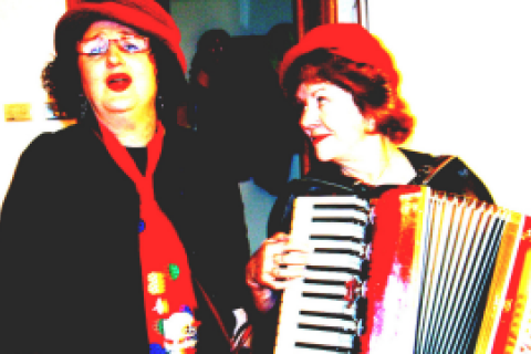 Trish (l) stands with Valerie as part of radical musical group 'Reds Under the Bed'