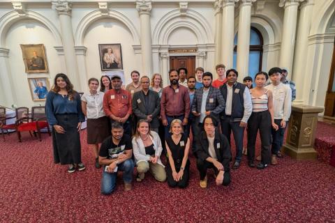 A photograph of protesters gathered together inside parliament house in Victoria.  