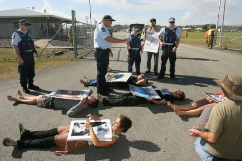 Robin Taubenfeld (bottom left) and others blocking the entrance to Camp Rocky as a part of the Talisman Sabre war games protests