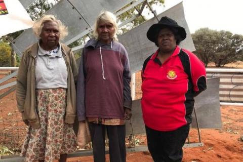 Shirley Wonyabong, Elizabeth Wonyabong, and Vicky Abdullah, standing in front of entrance to Yeelirrie Pastoral lease gates